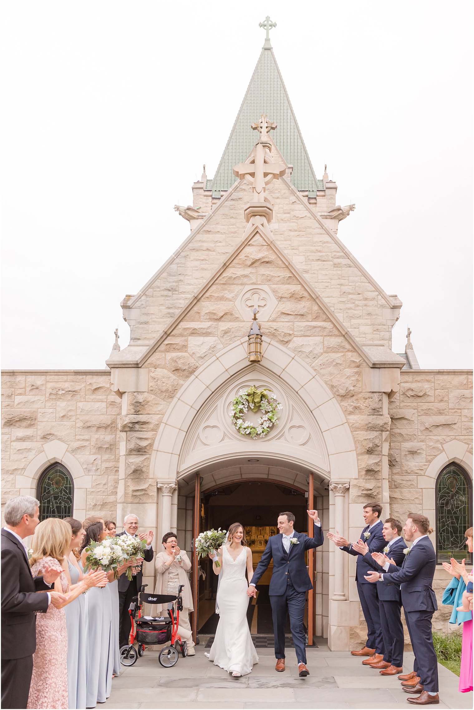 bride and groom leave St. Vincent Martyr Church with guests cheering them