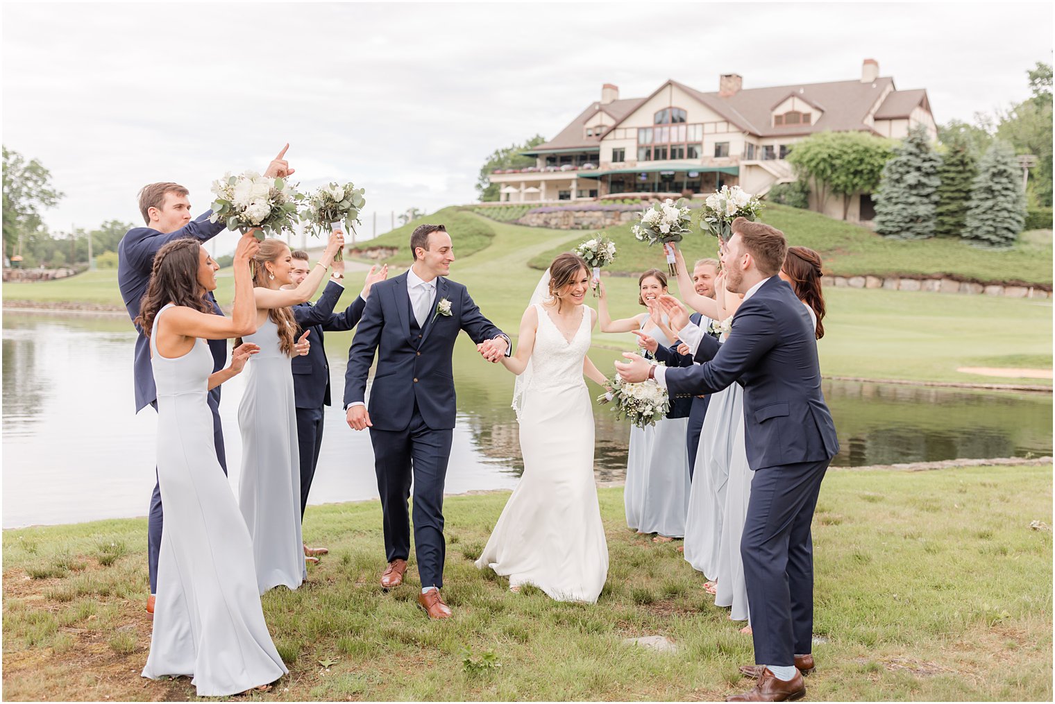 newlyweds walk around with wedding party at Spring Brook Country Club