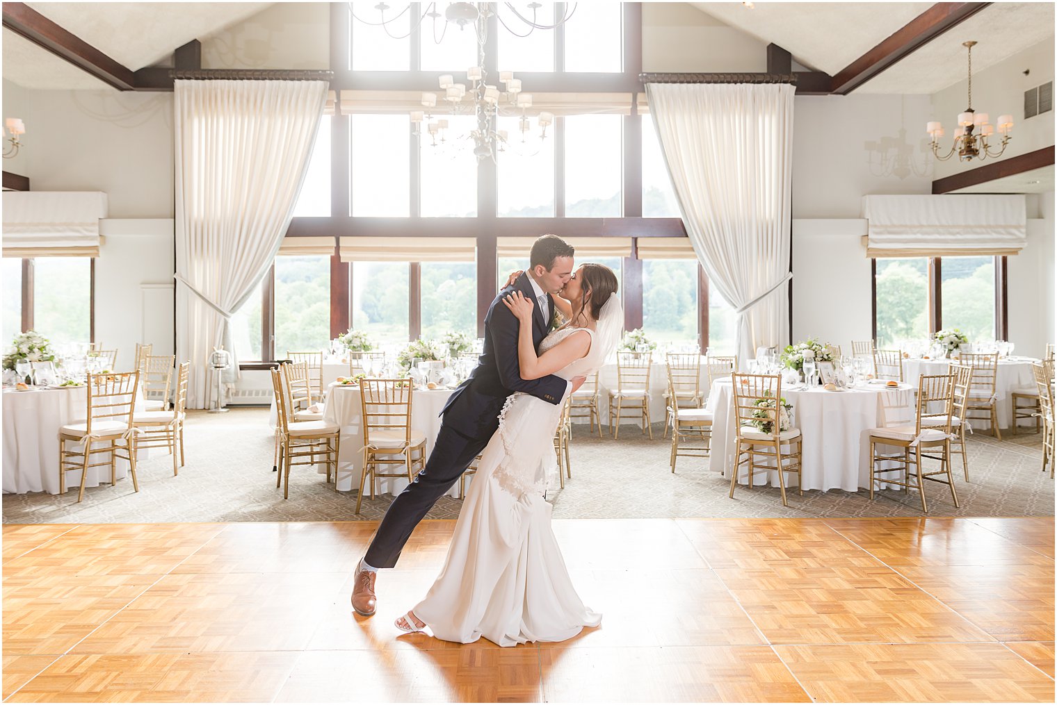 bride and groom kiss inside reception at Spring Brook Country Club