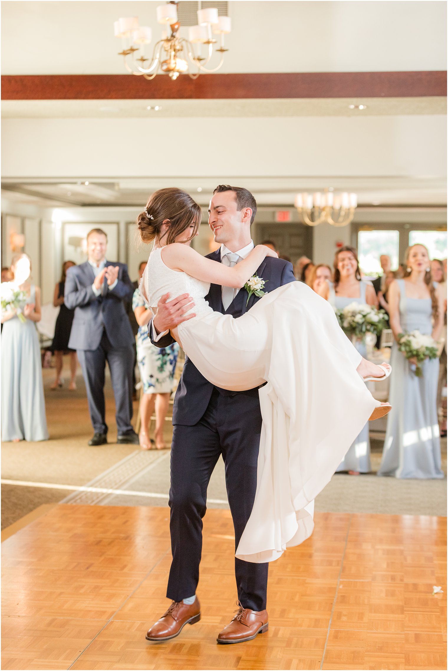 groom lifts bride during Morristown NJ wedding reception