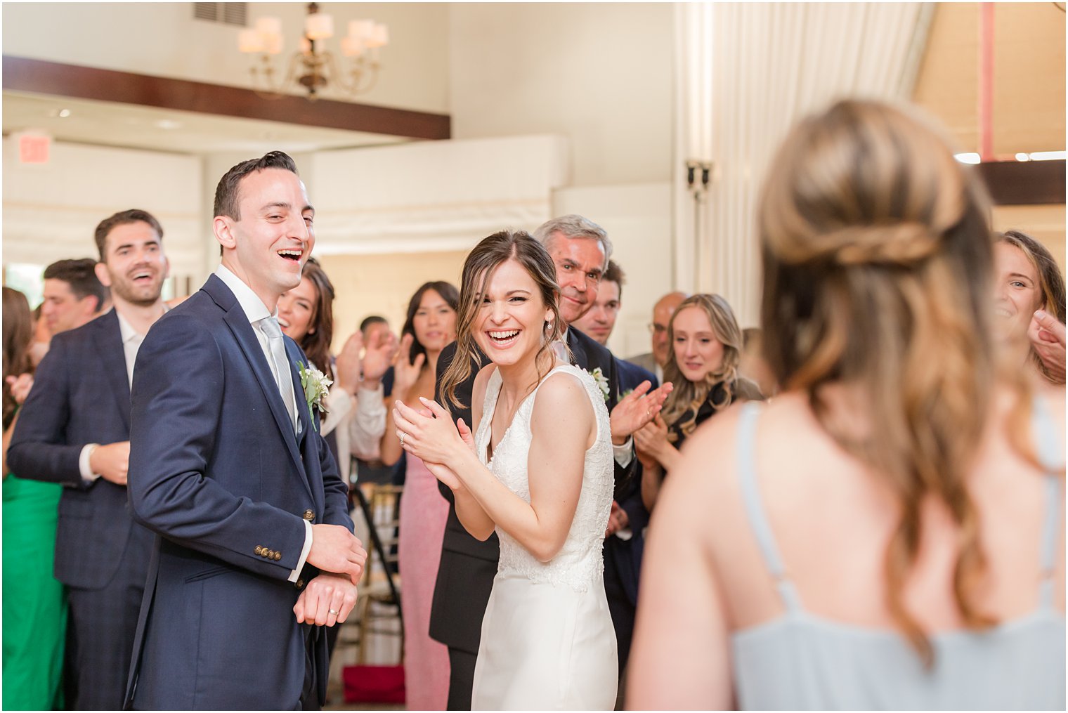 bride laughs during bridesmaid's toast at Morristown NJ wedding reception
