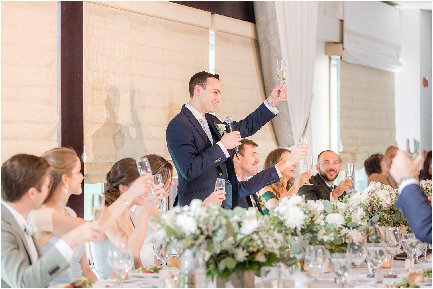 groom lifts glass in toast at Morristown NJ wedding reception