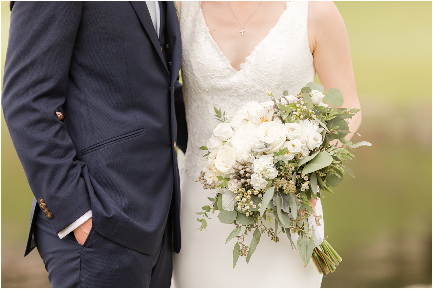 bride holds bouquet all white flowers 