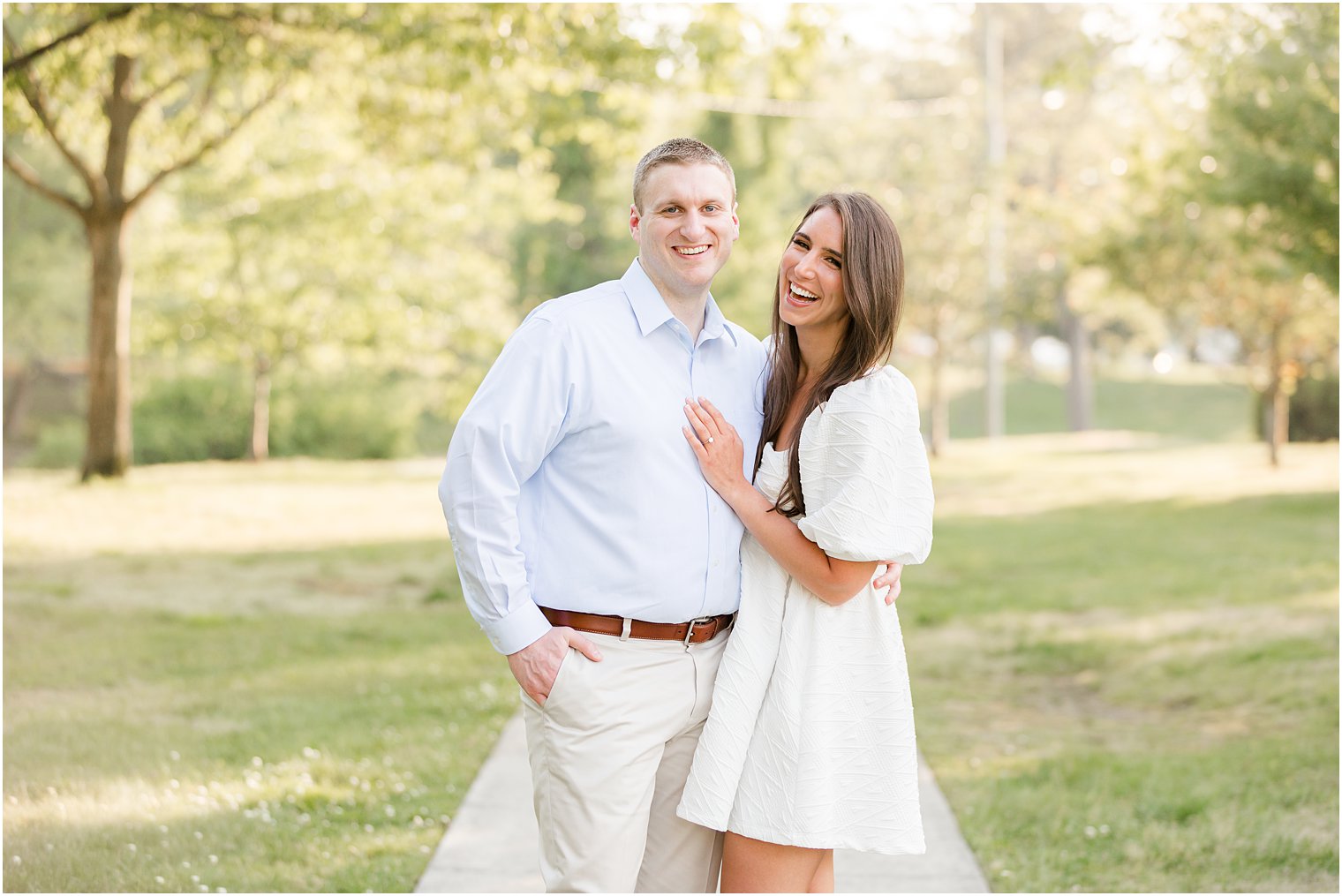 couple laughs together during Spring Lake engagement session