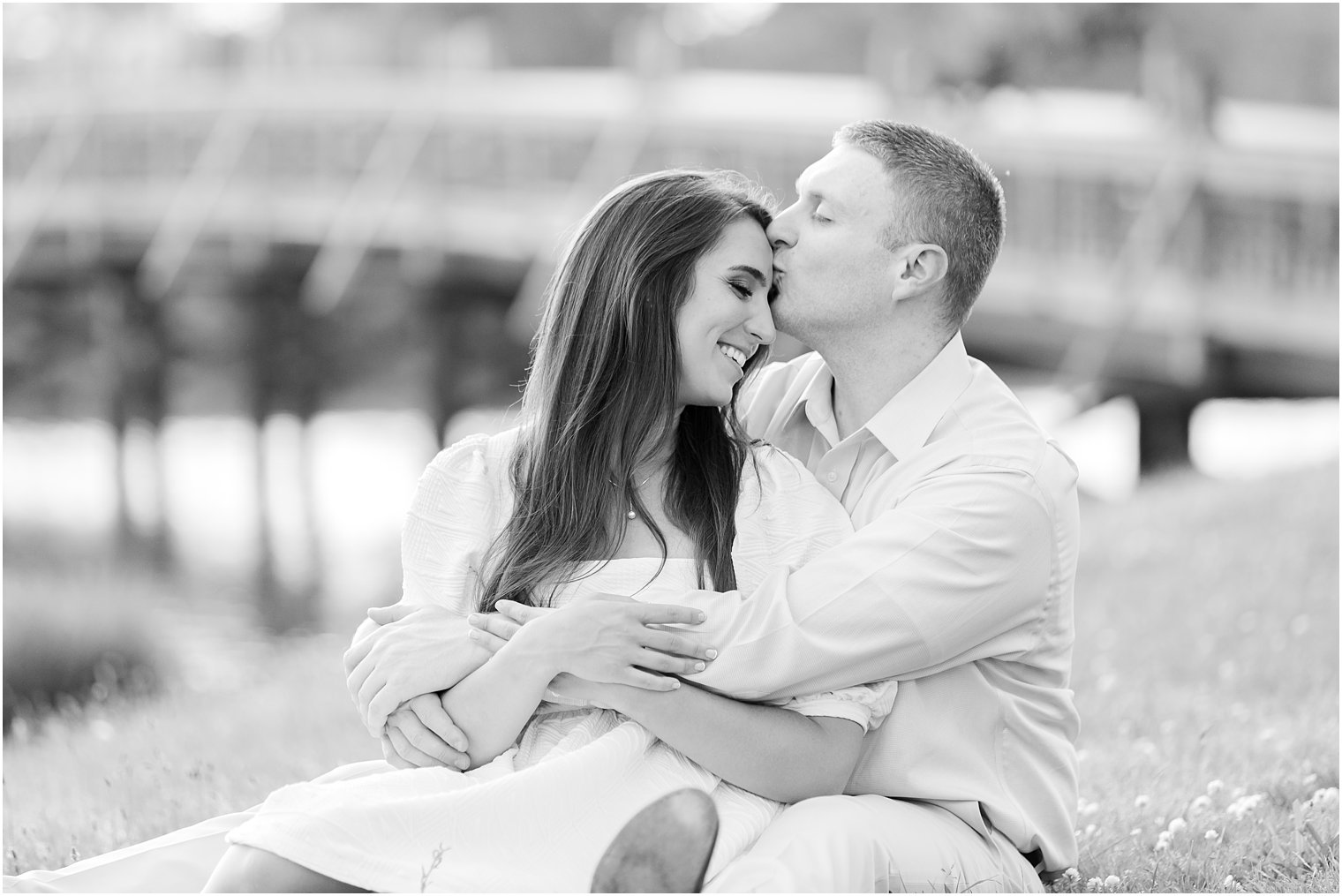 man kisses fiancee's forehead during Spring Lake engagement session
