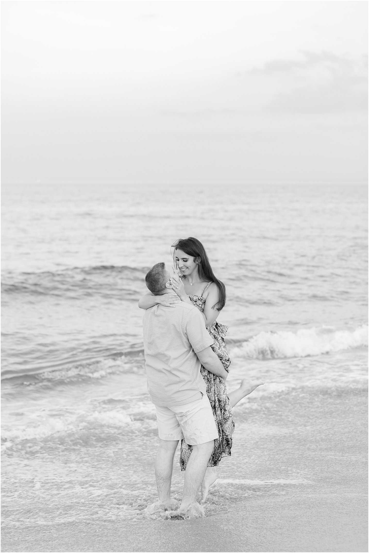 groom lifts bride during Spring Lake engagement session