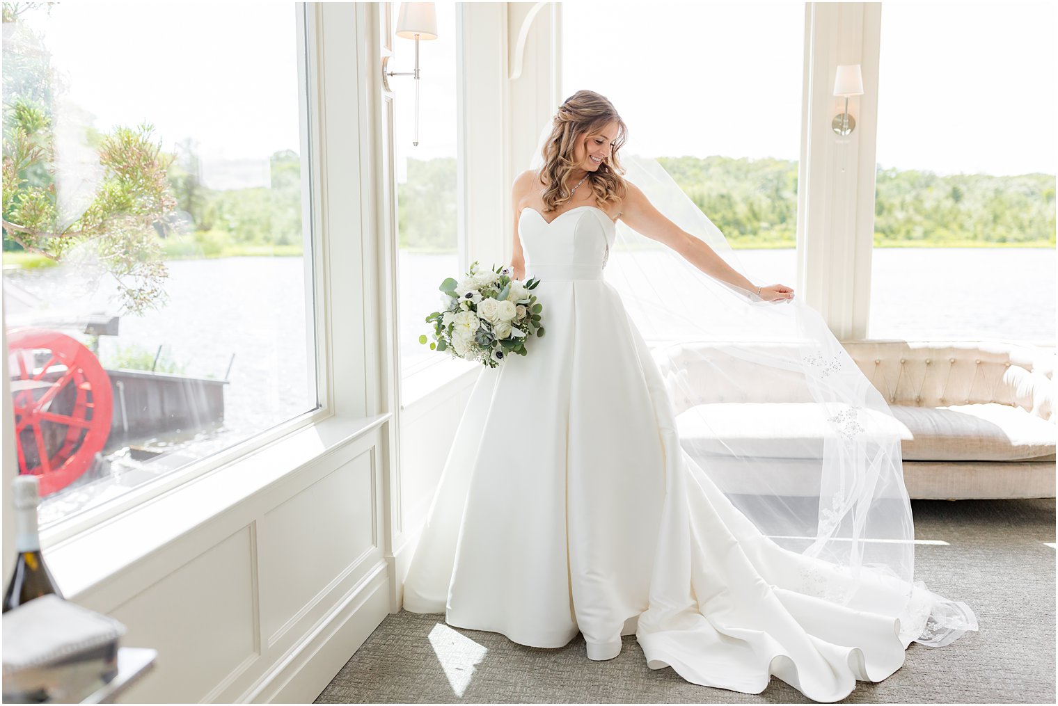 bride holds out veil before The Mill Lakeside Manor wedding