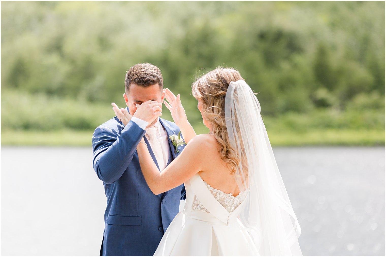 bride and groom cry during first look on dock at The Mill Lakeside Manor