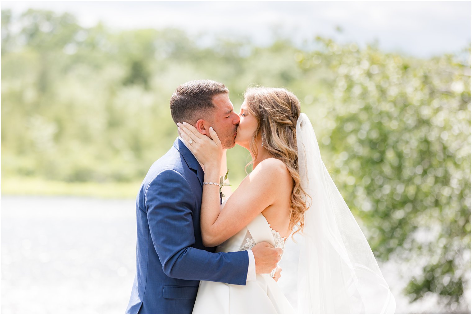 bride kisses groom during first look at The Mill Lakeside Manor