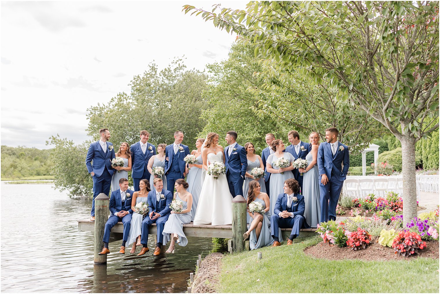 bride and groom pose with wedding party in light blue dresses and navy suits at The Mill Lakeside Manor wedding