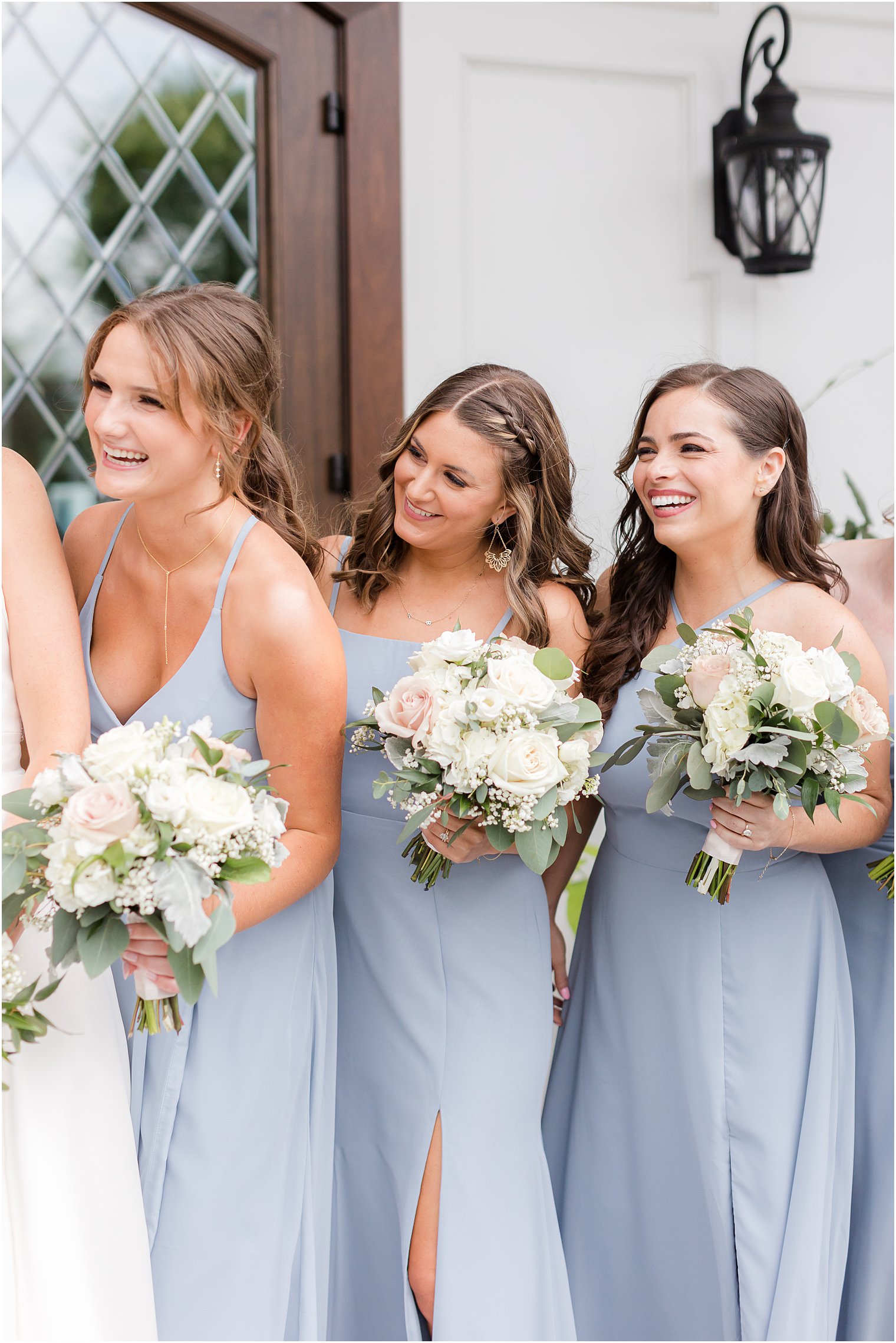 bridesmaids smile at bride in blue gowns