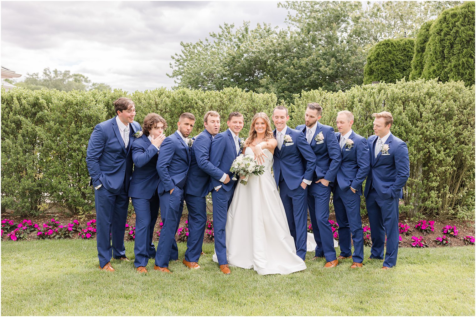 bride shows off ring to groomsmen before NJ wedding