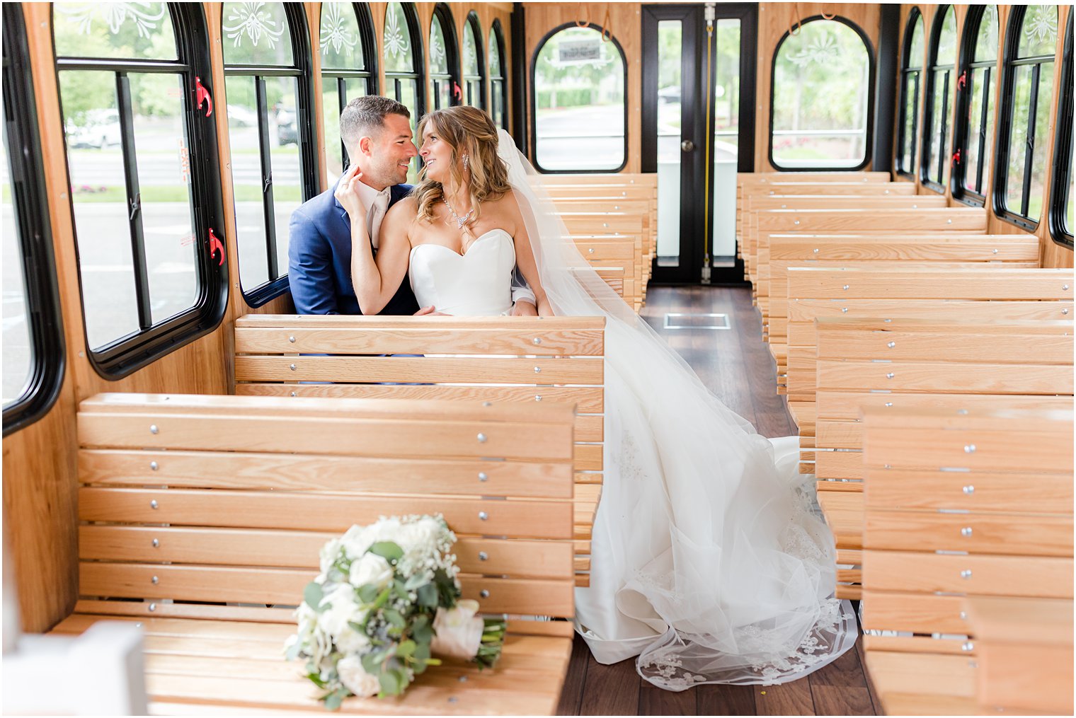 bride and groom sit on trolley together