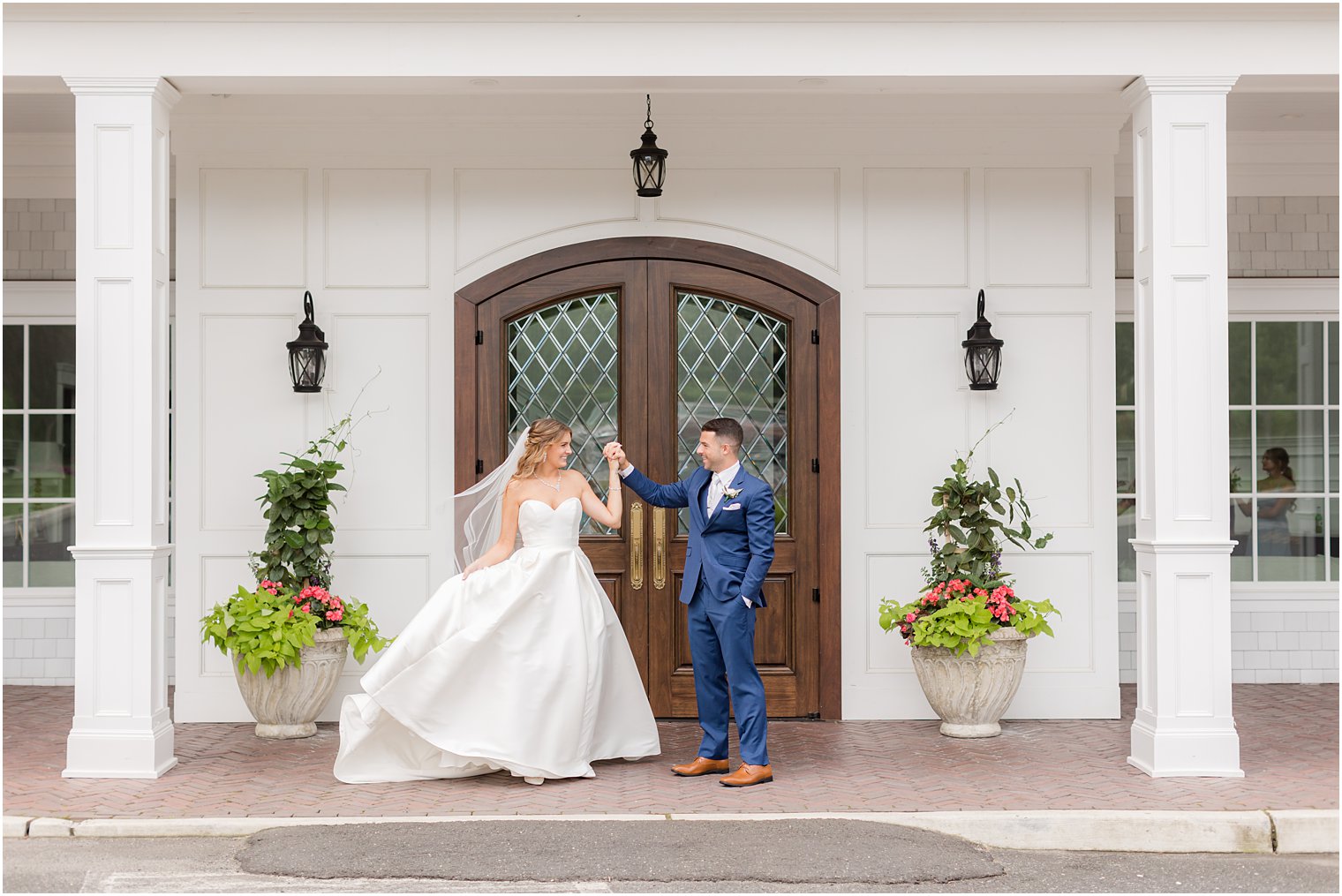 groom twirls bride during portraits outside The Mill Lakeside Manor