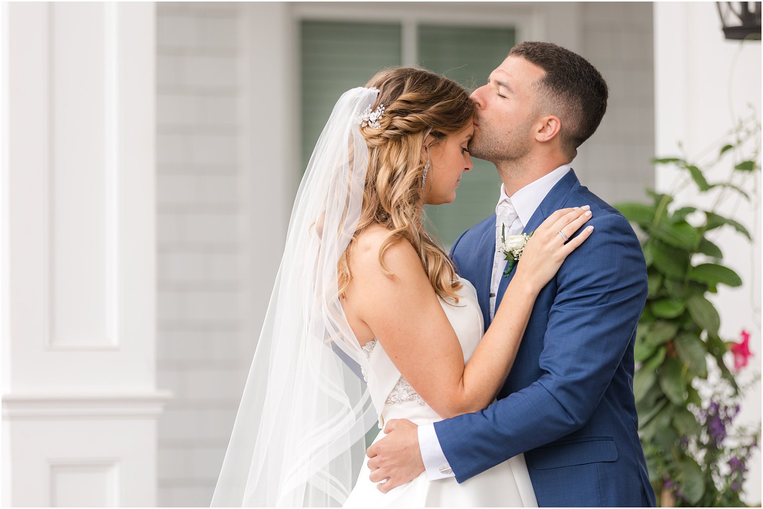 groom kisses bride's forehead at The Mill Lakeside Manor