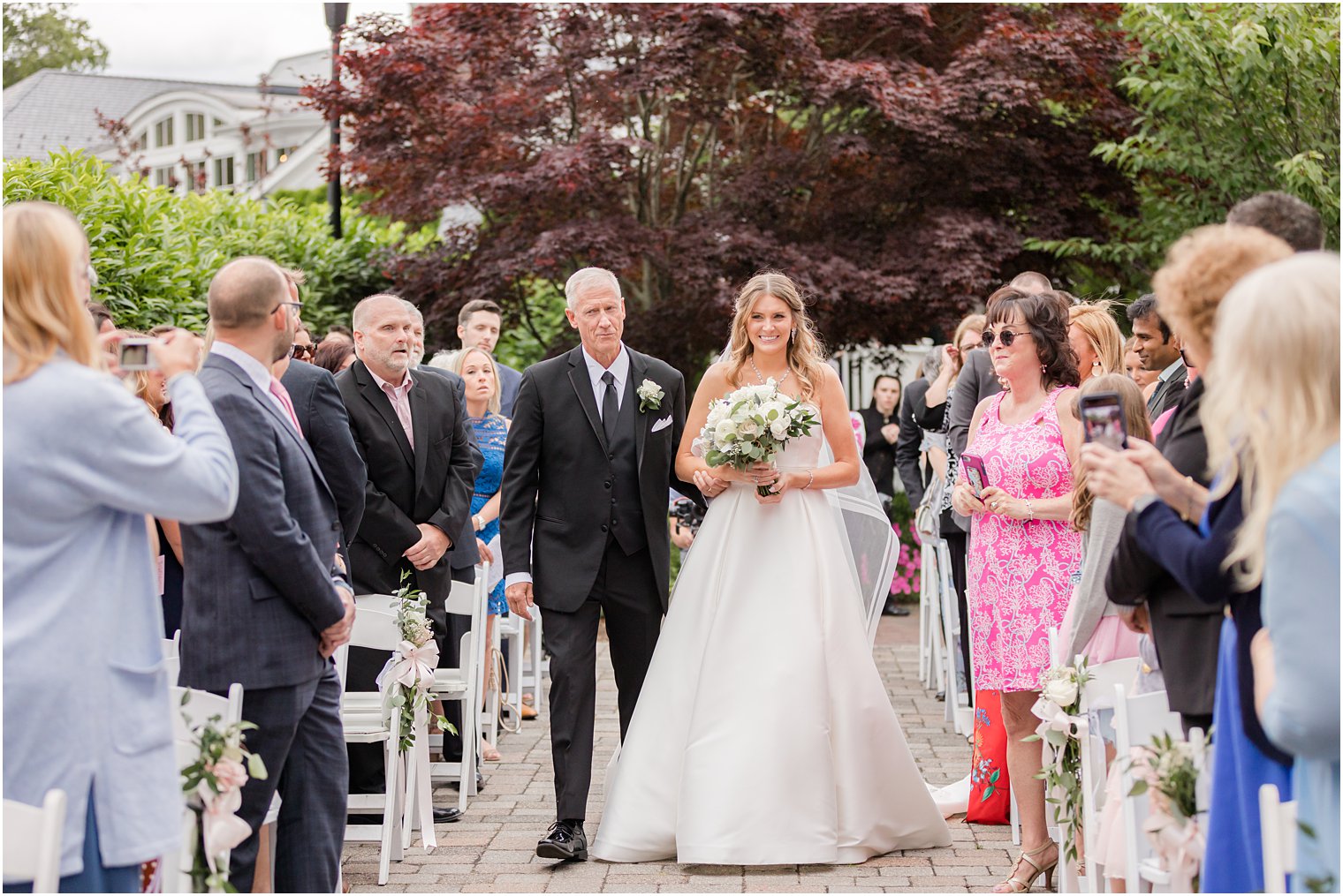 bride walks into wedding ceremony with dad