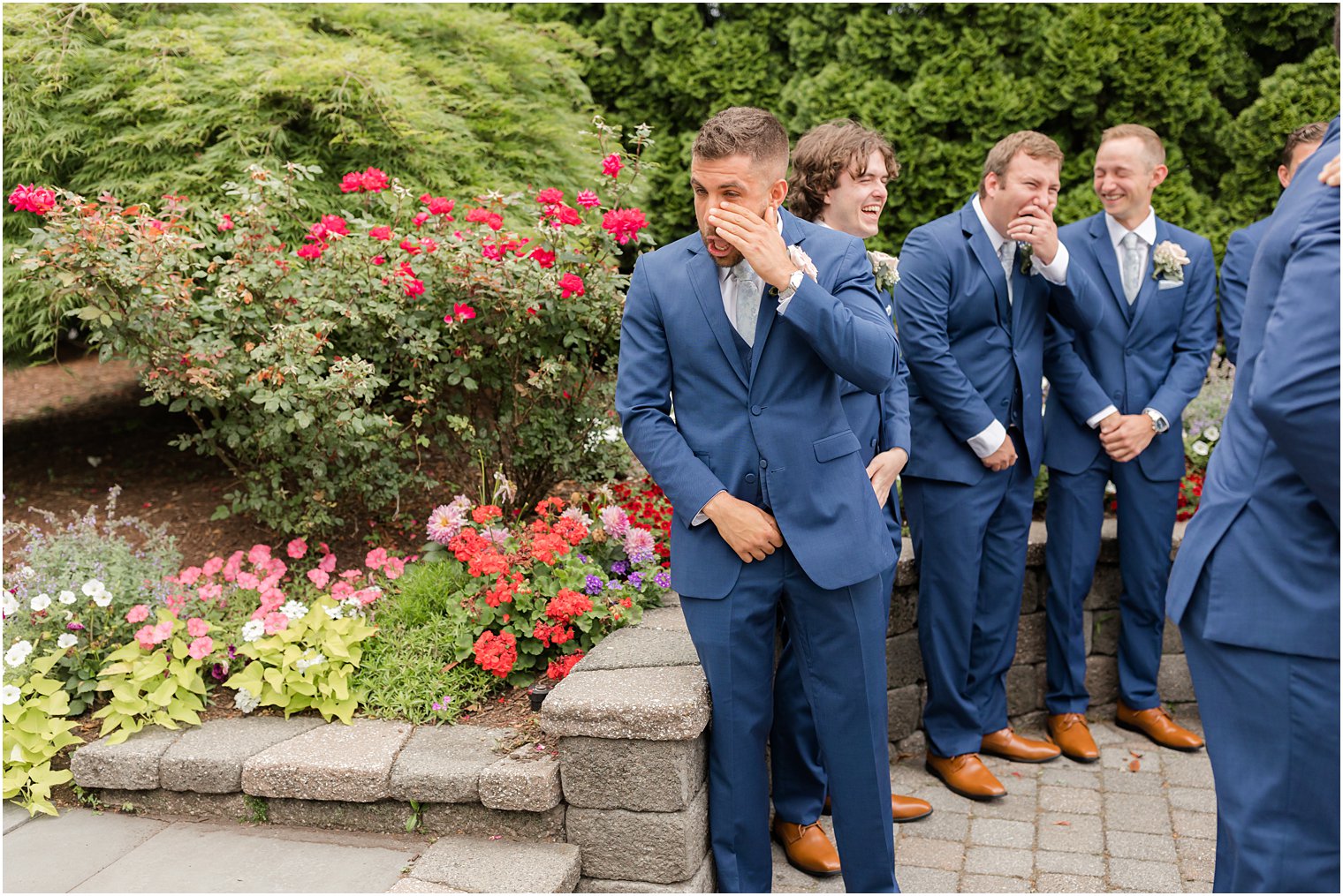 groom turns to wipe tear during Spring Lake NJ wedding ceremony