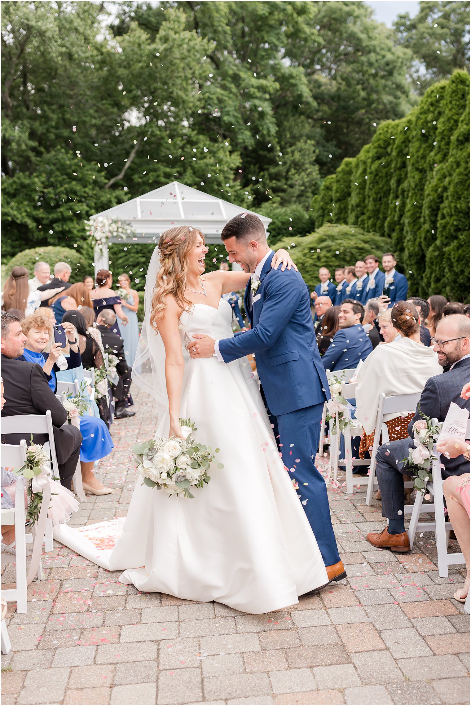 groom leans to dip bride during Spring Lake NJ wedding ceremony confetti exit 