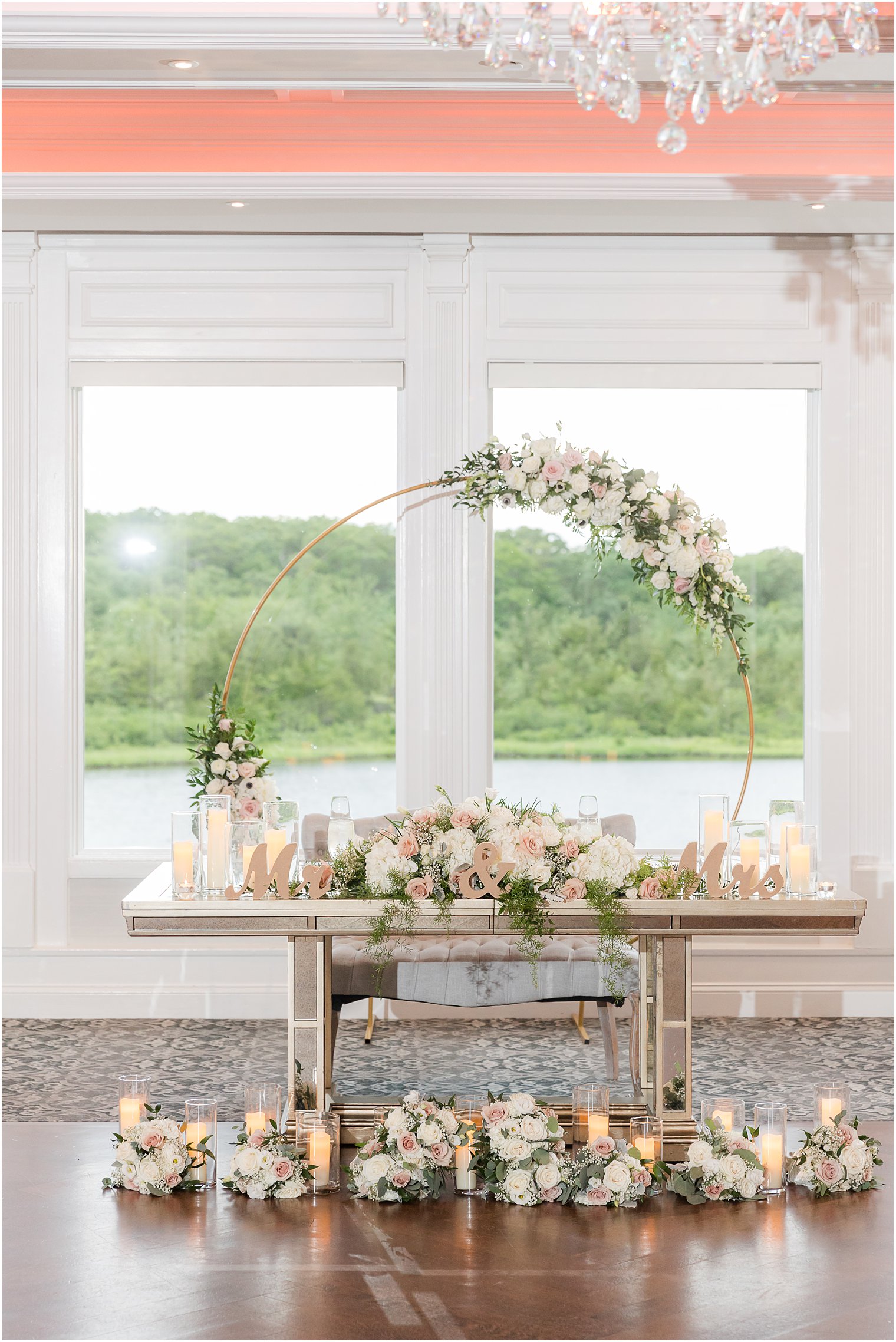 sweetheart table with candles and floral covered hoop