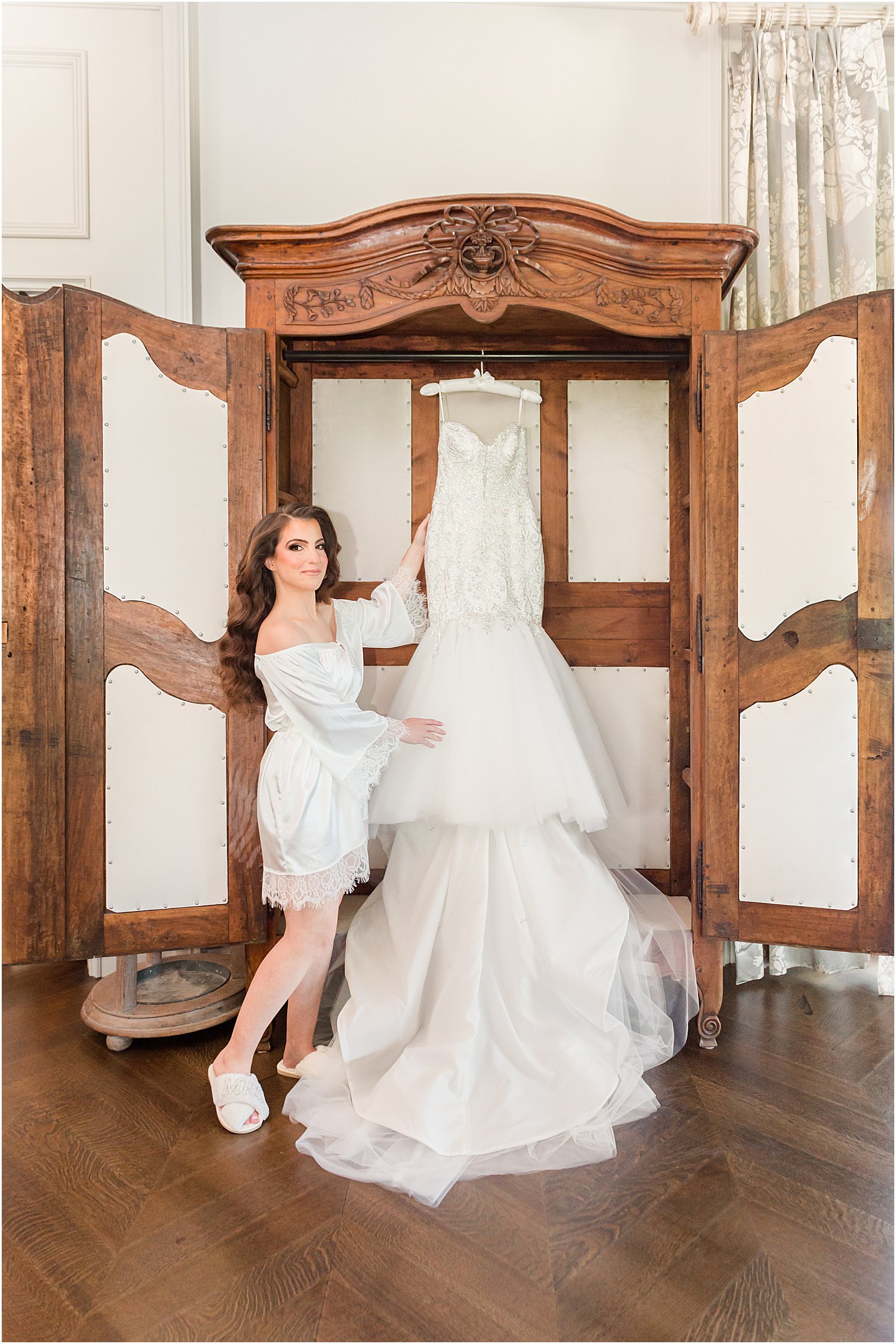 bride looks at wedding dress hanging in bridal suite at Park Chateau Estate 