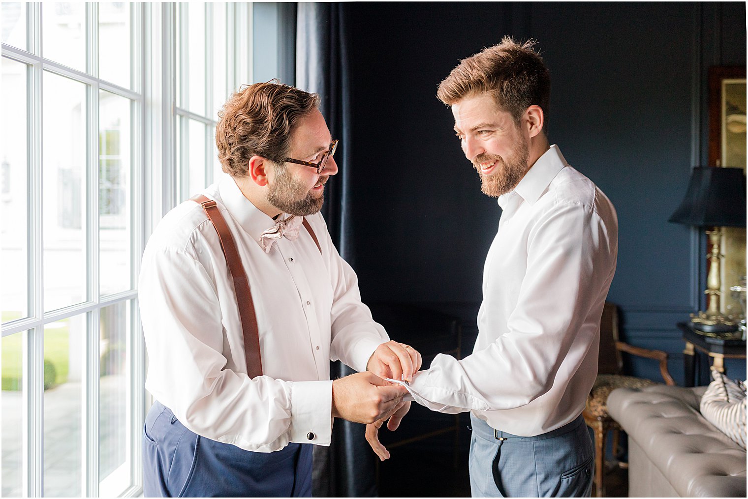 groomsman helps groom prep for summer Park Chateau Estate wedding