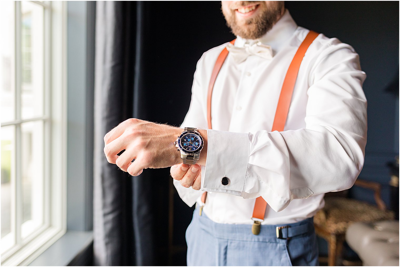 groom adjusts watch before Park Chateau Estate wedding day