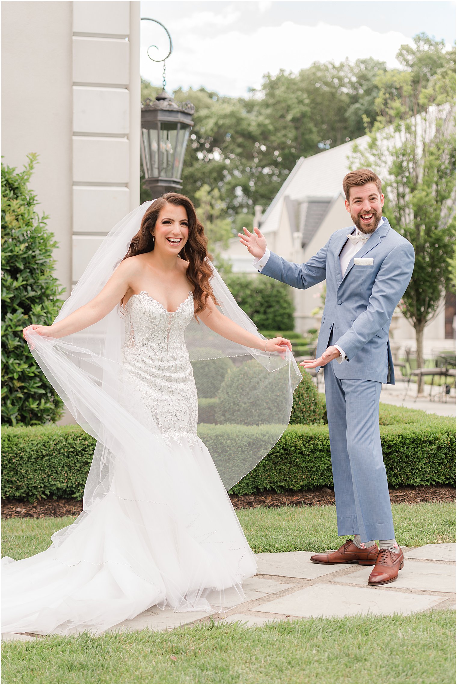 groom shows off bride in wedding gown in New Jersey 