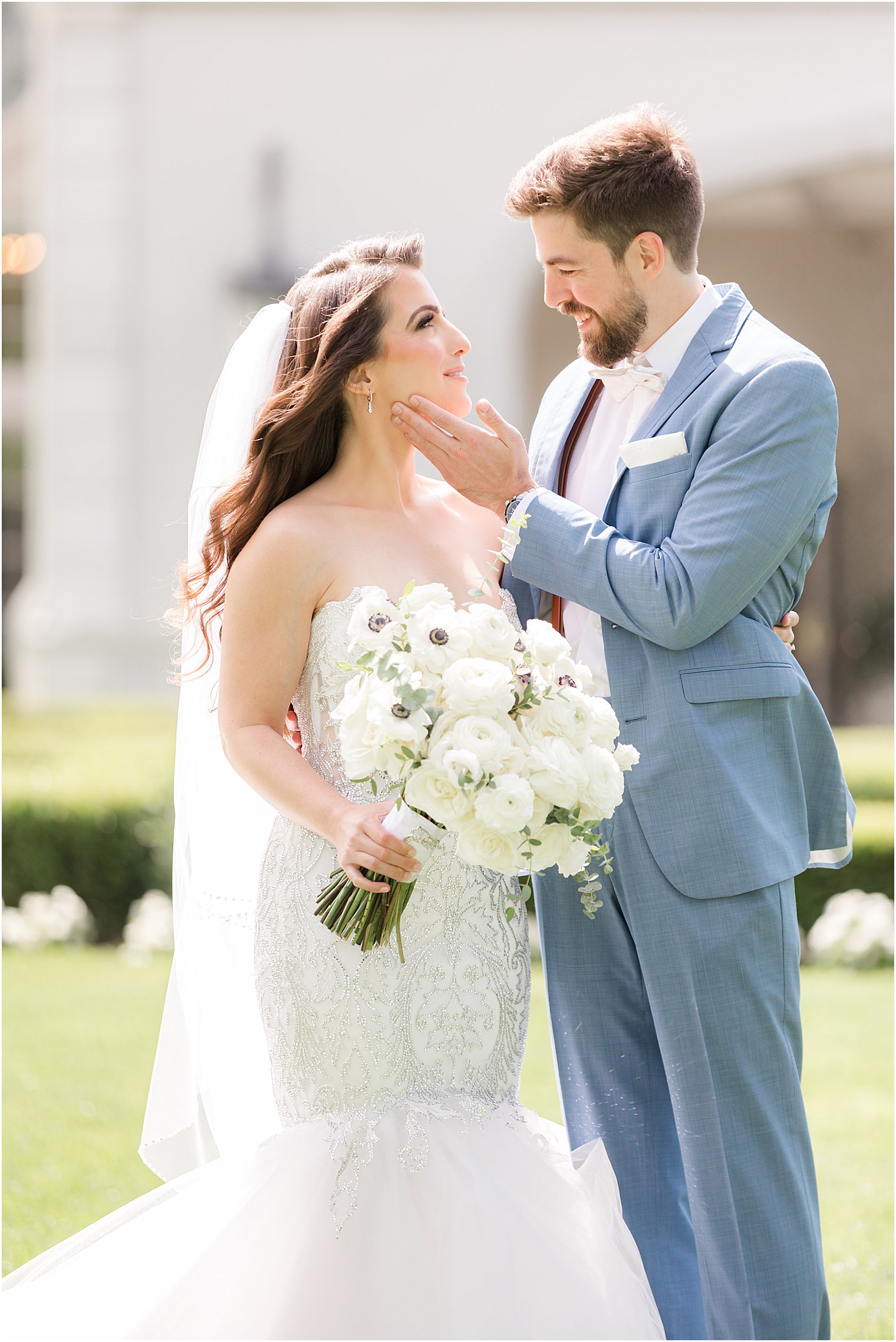 groom tilts up bride's chin during portraits in New Jersey