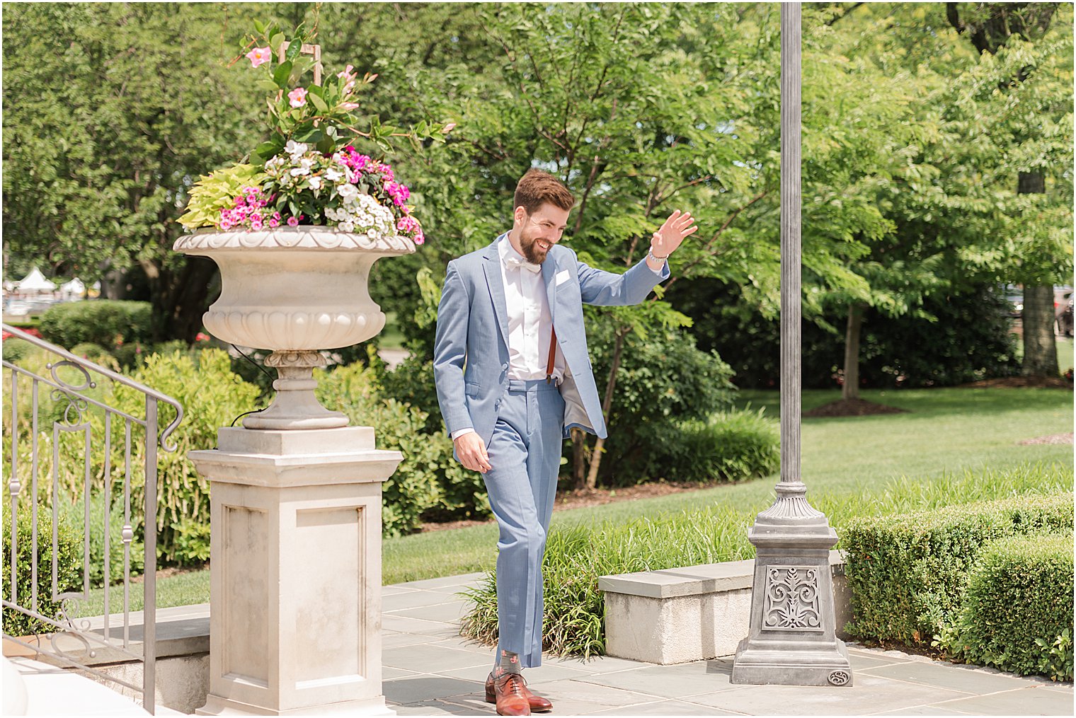 groom enters wedding ceremony in garden of Park Chateau Estate