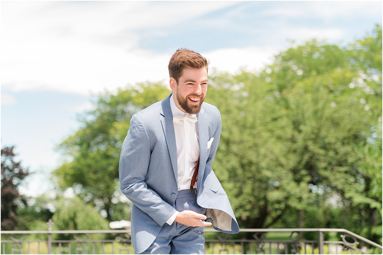 groom smiles watching bride enter wedding ceremony