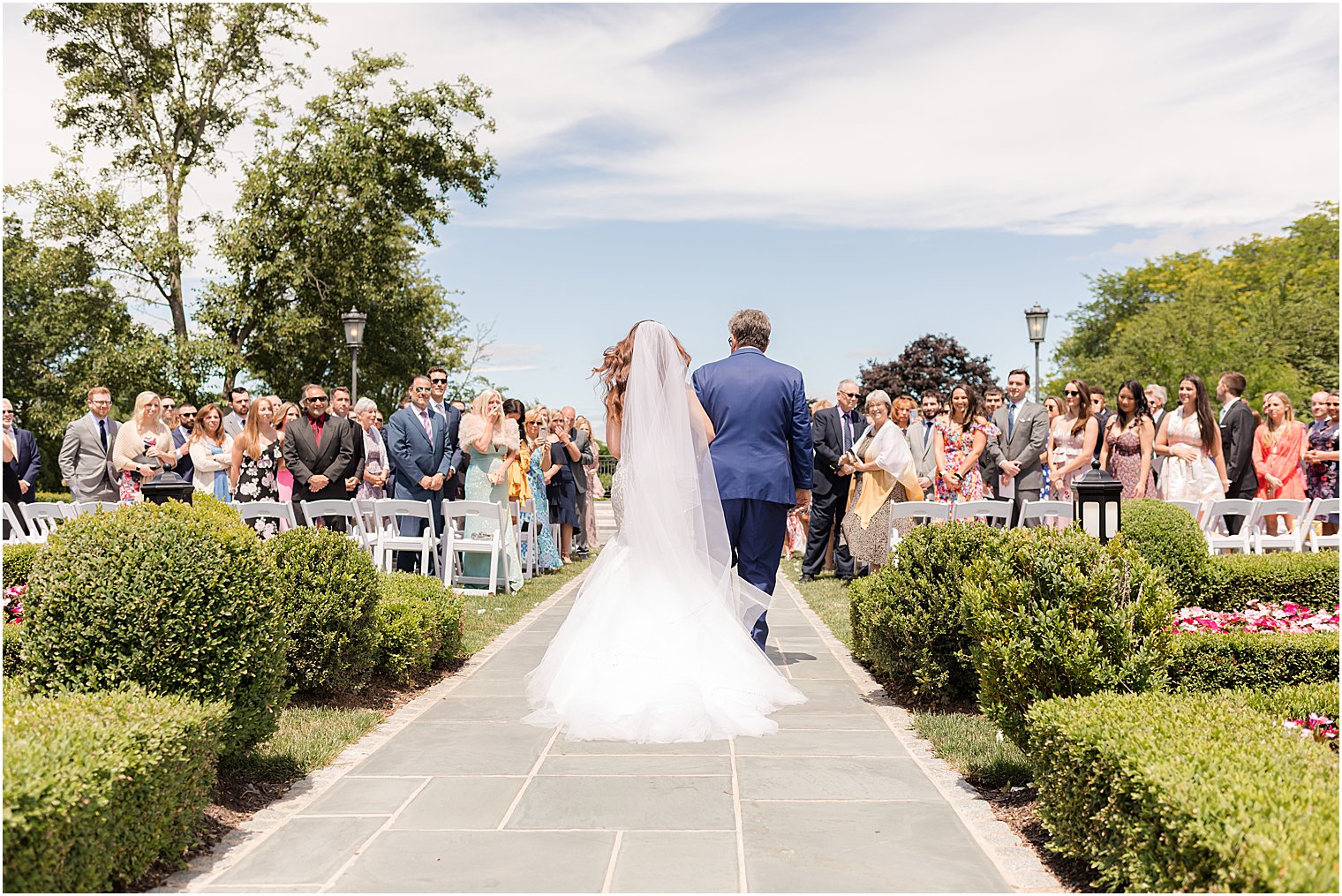 bride walks up aisle with dad at Park Chateau Estate