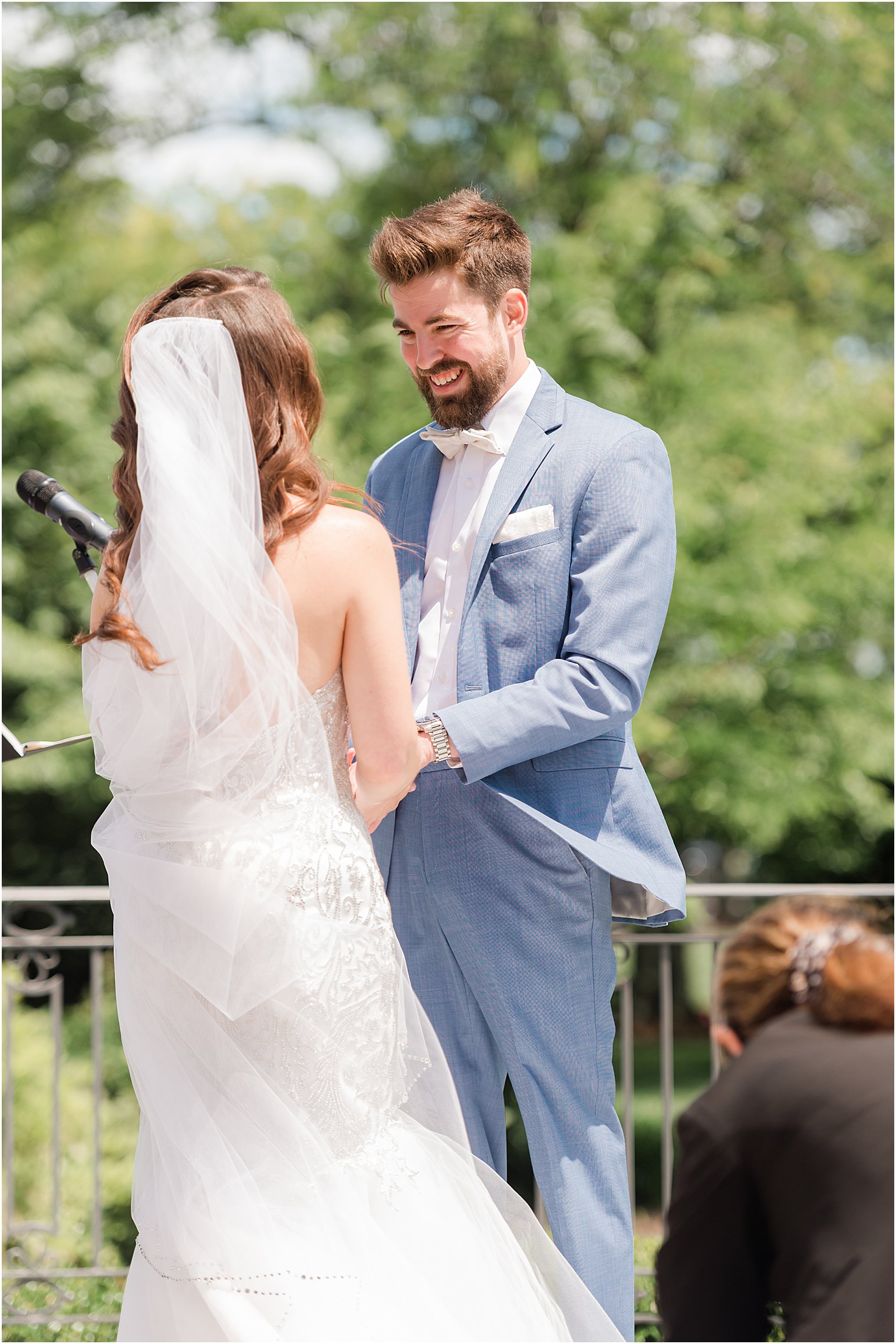 groom looks at bride during wedding ceremony at Park Chateau Estate