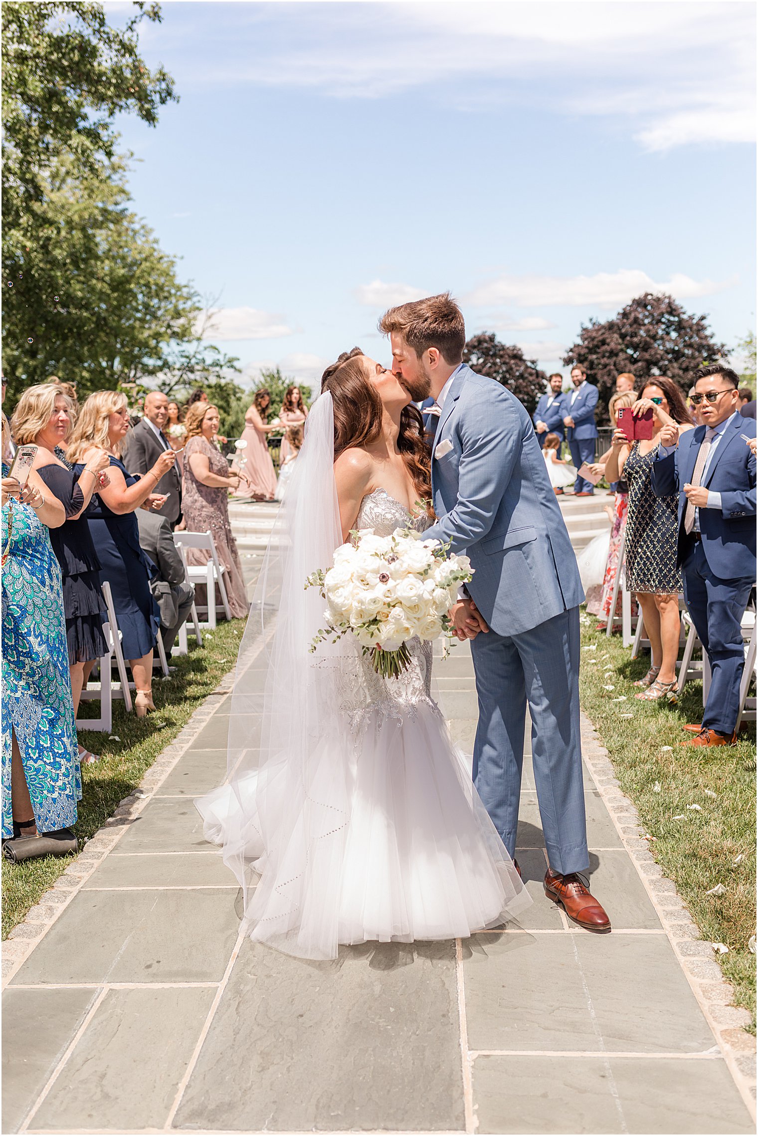 bride and groom kiss n aisle after ceremony at Park Chateau Estate