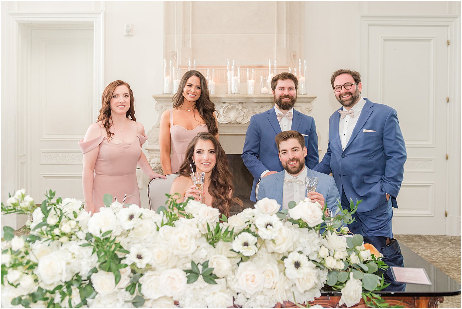 newlyweds pose with best men and maids of honor