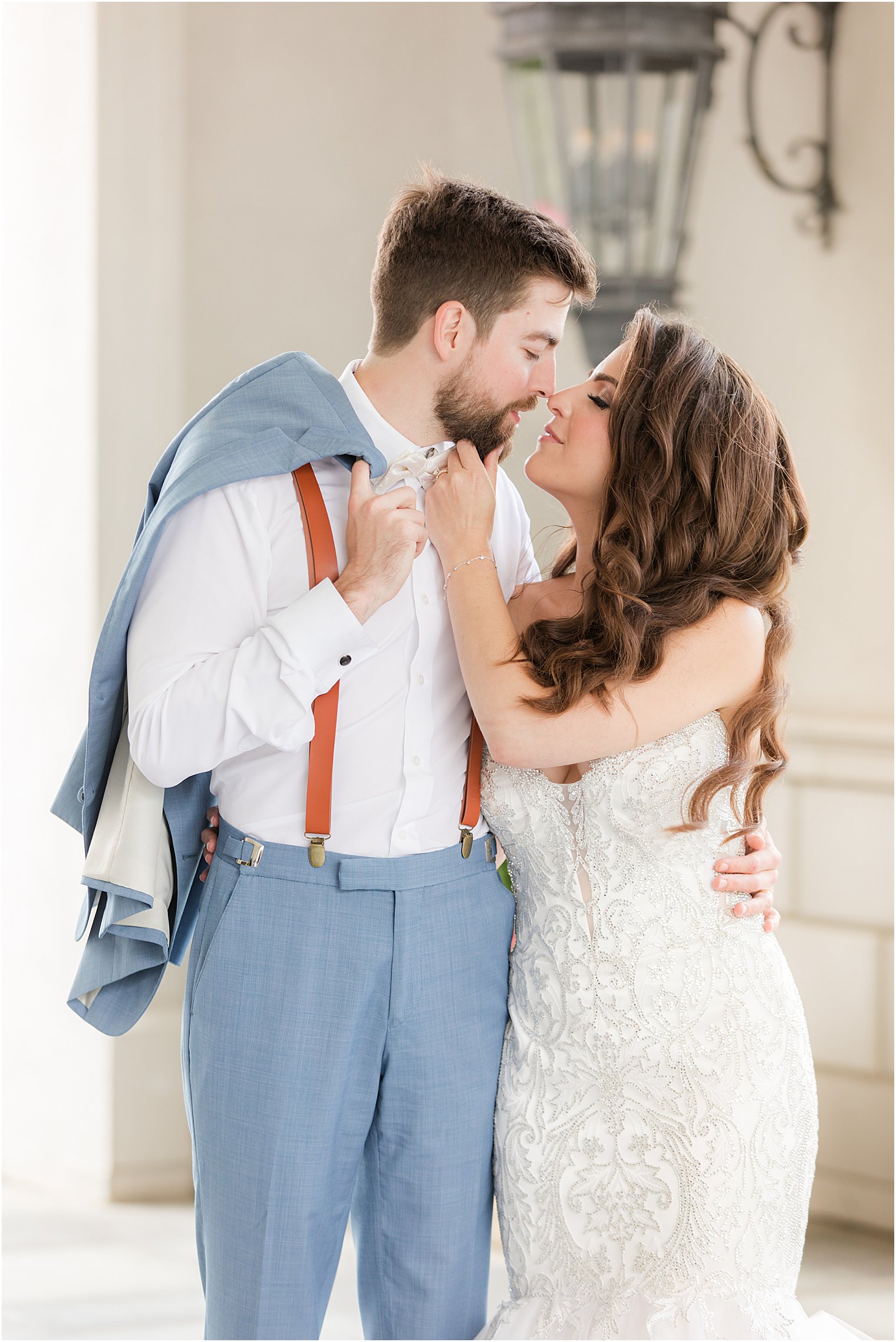 newlyweds kiss under archway at Park Chateau Estate