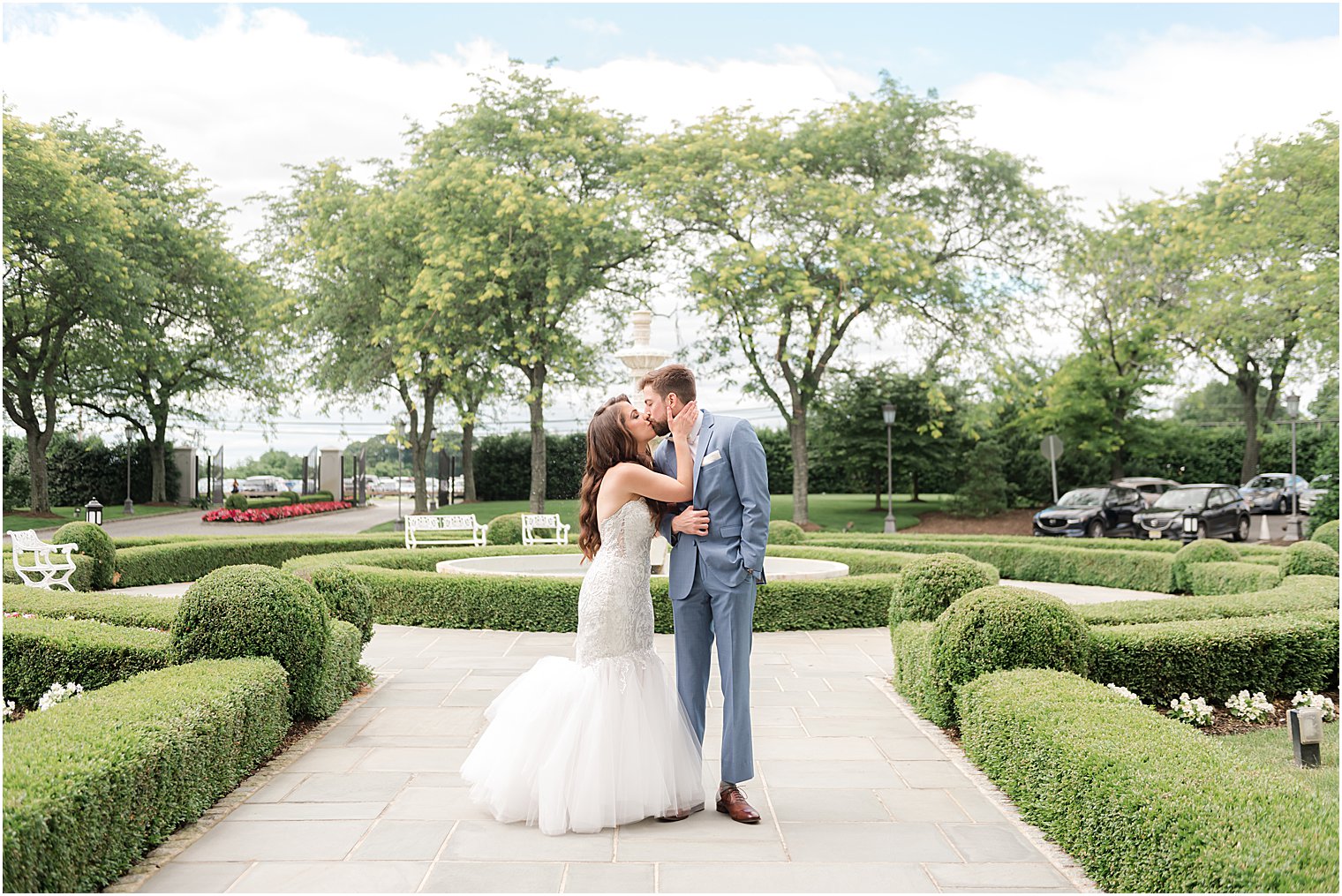 bride and groom kiss on walkway of garden at Park Chateau Estate
