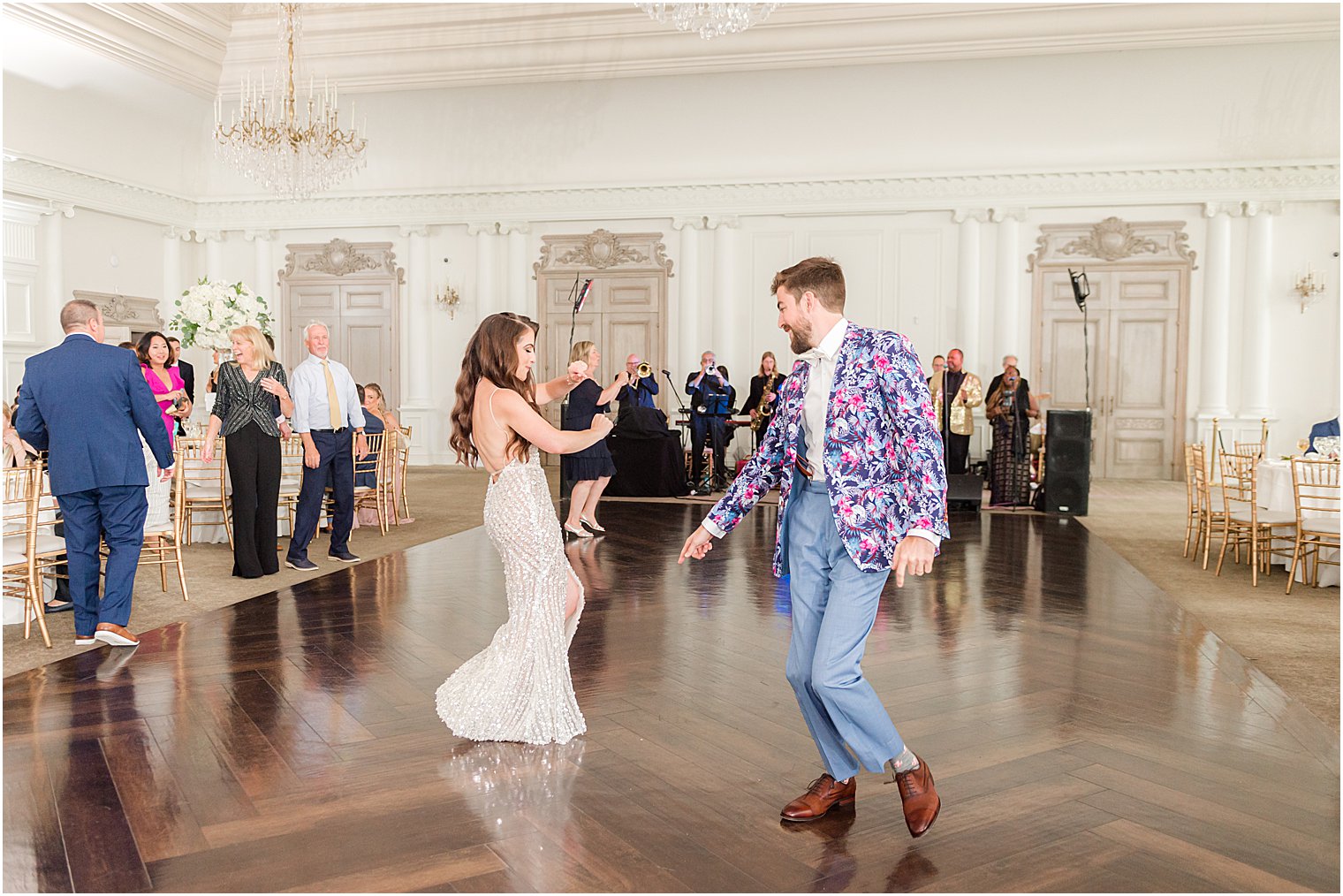 newlyweds dance in party outfits at Park Chateau Estate