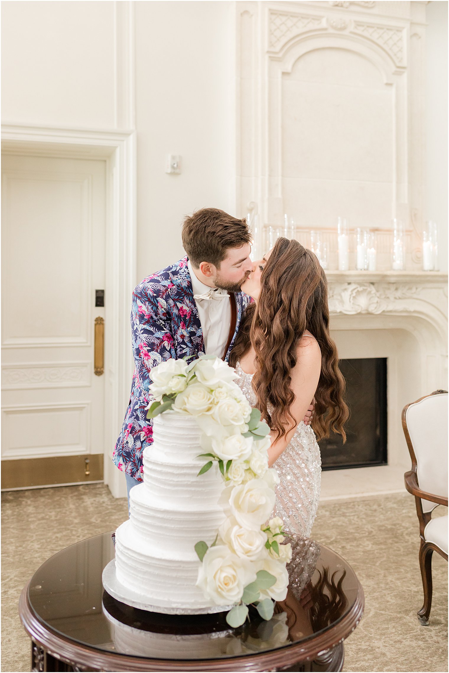 bride and groom kiss during cake cutting