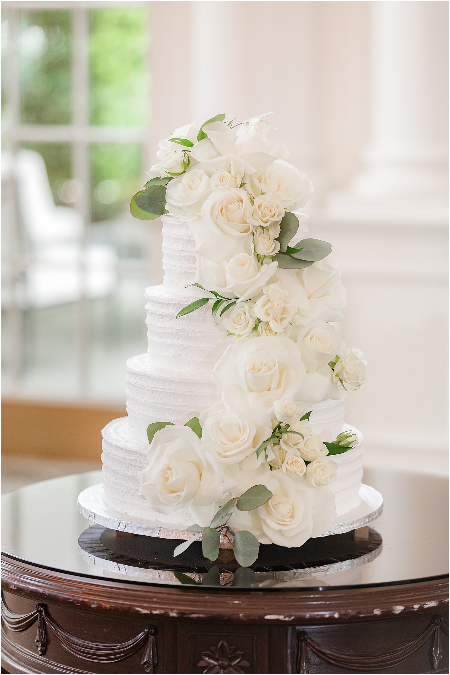 tiered wedding cake with white flower accents