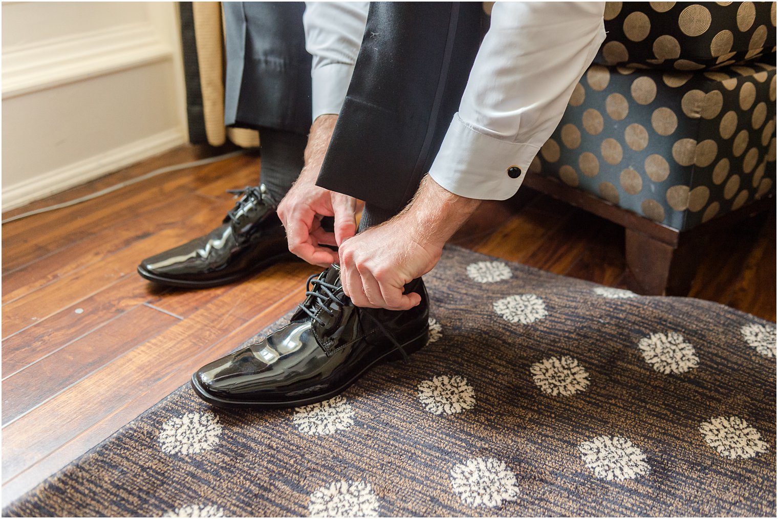 groom adjusts shoe before New Jersey wedding day