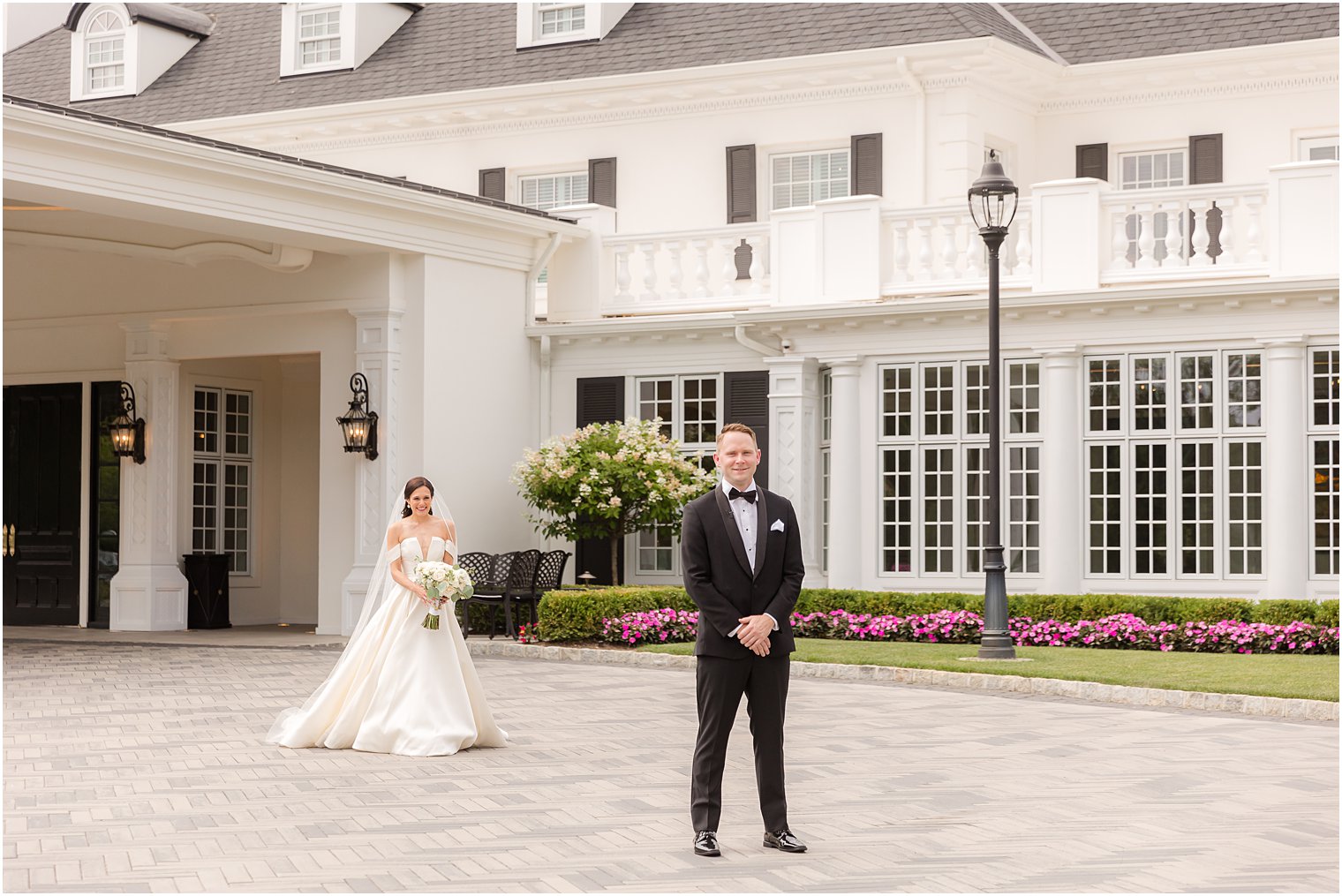 bride approaches groom for first look outside Shadowbrook at Shrewsbury