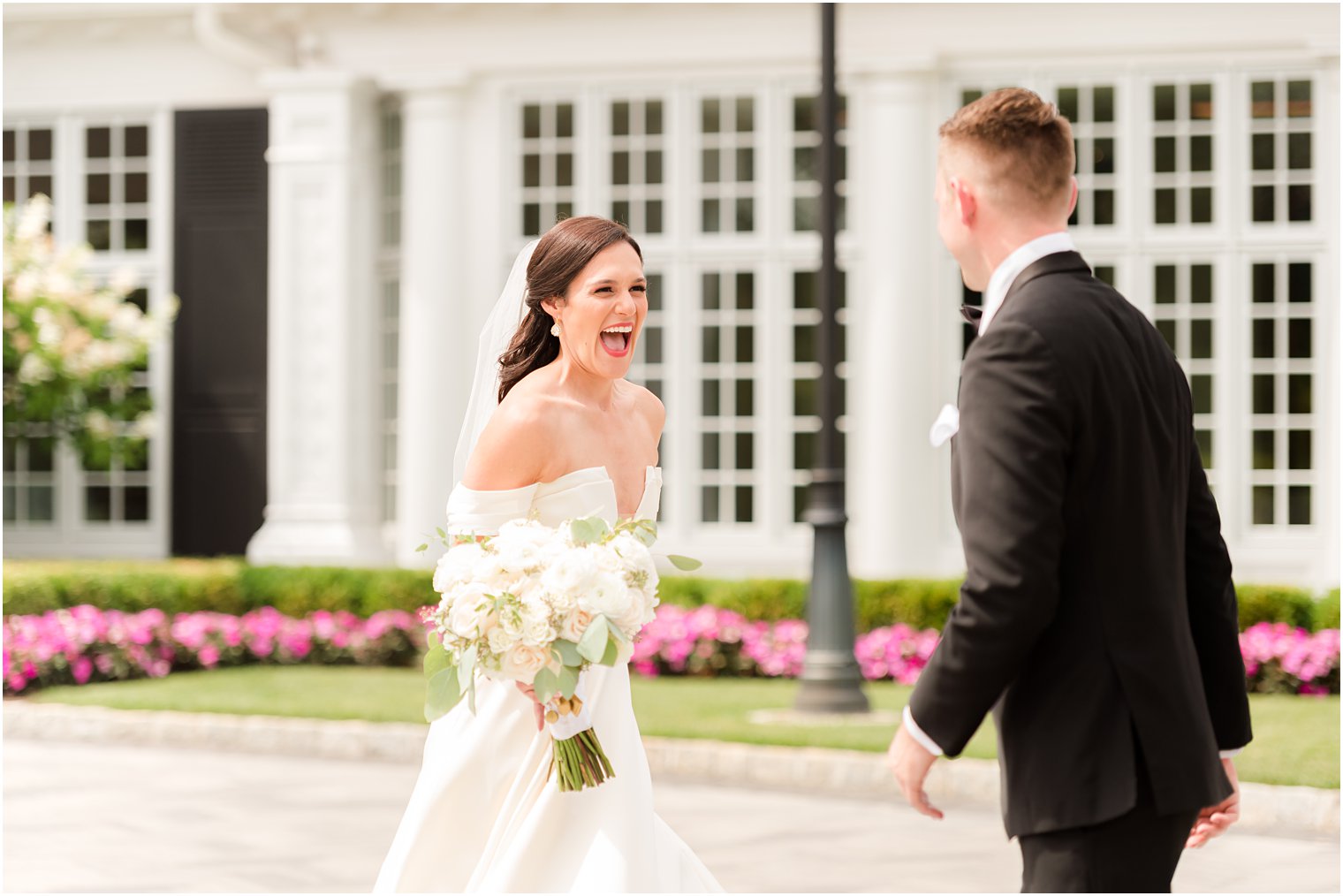 bride laughs seeing groom during first look 