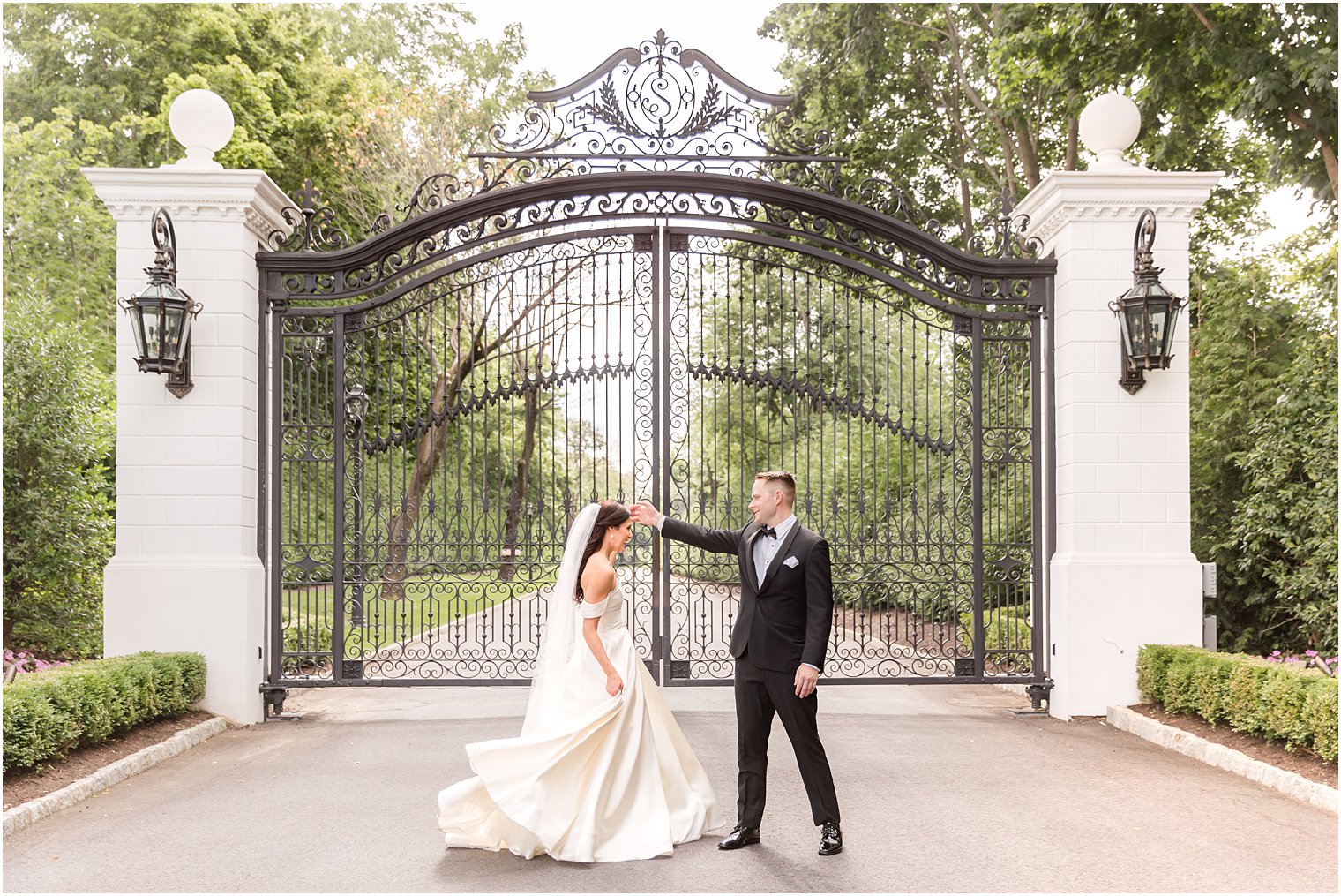 groom twirls bride outside gate at Shadowbrook at Shrewsbury