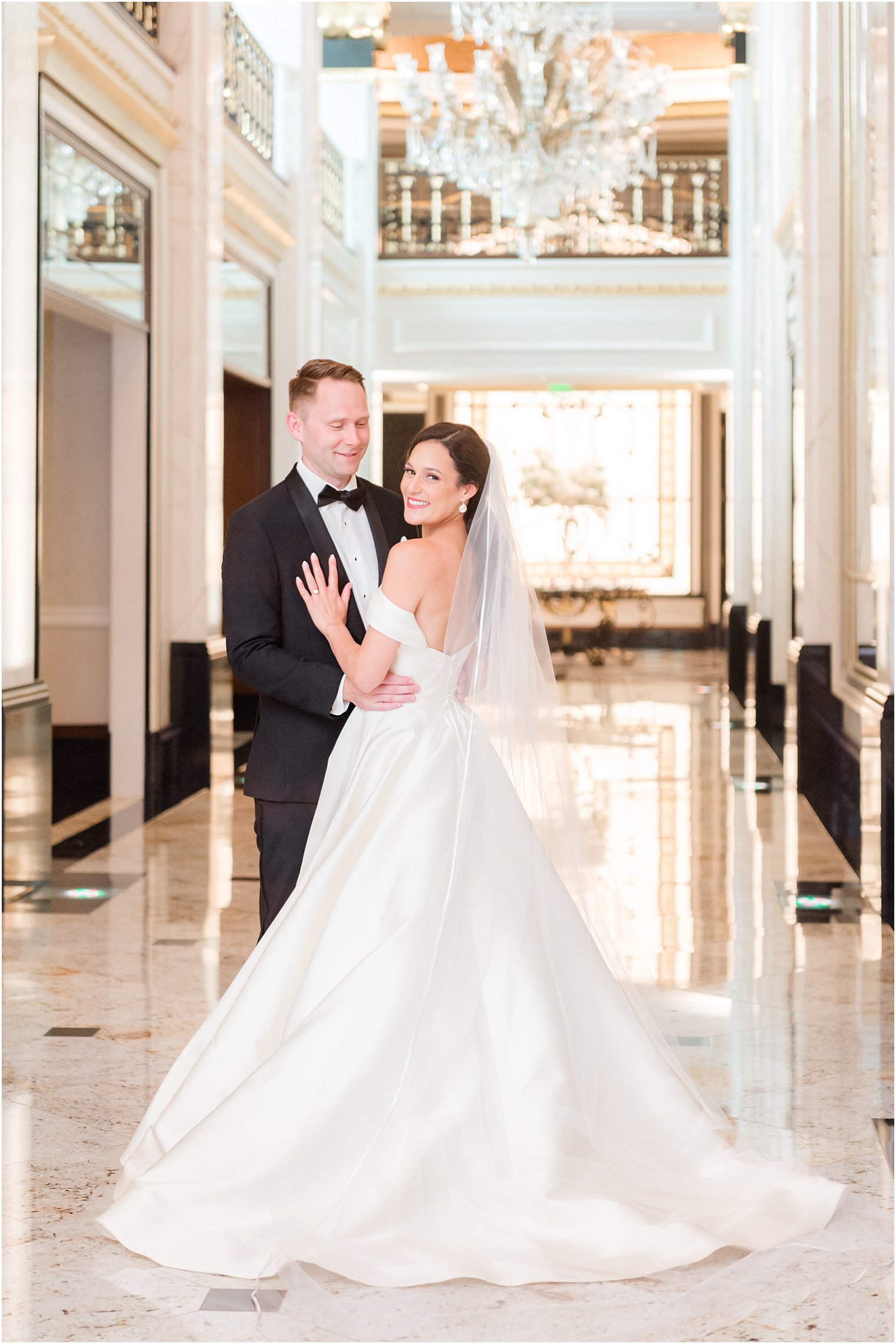 bride and groom pose in hallway at Shadowbrook at Shrewsbury