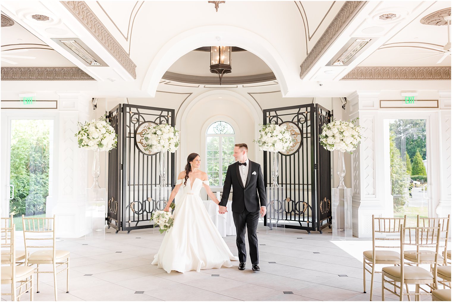 newlyweds hold hands in chapel at Shadowbrook at Shrewbsury