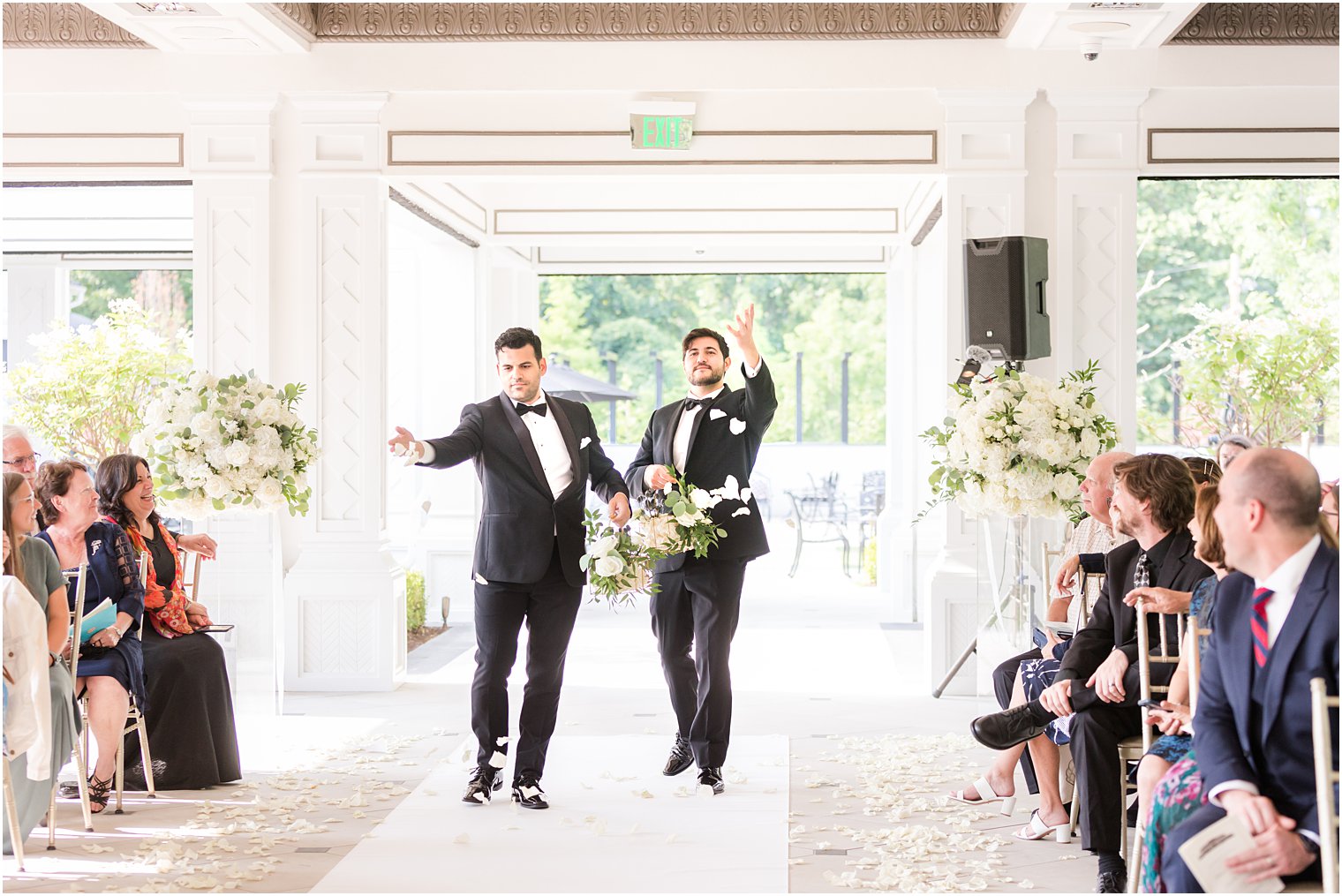 flower men walk down aisle throwing petals at Shadowbrook at Shrewbsury