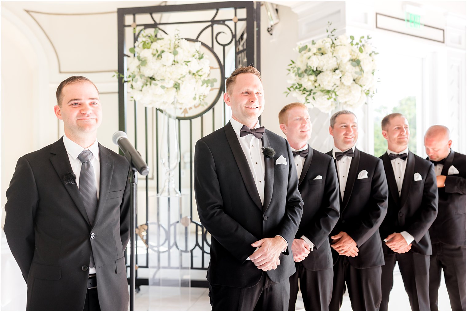 groom watches bride enter wedding ceremony 