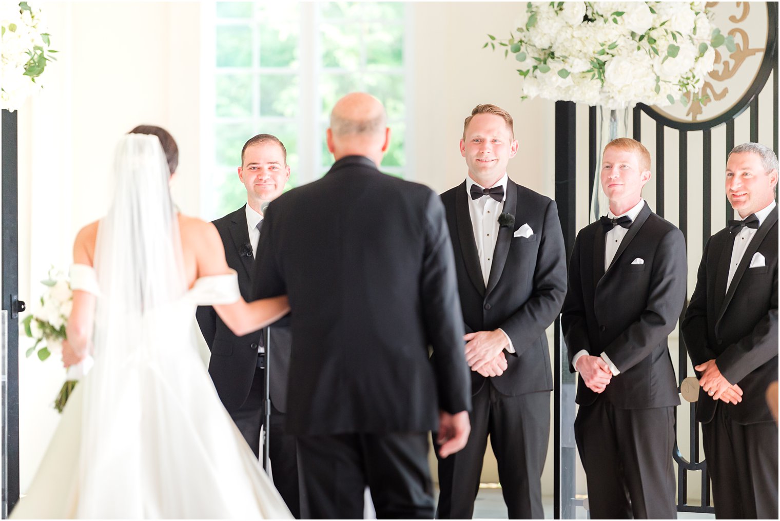 groom watches dad give away bride at Shadowbrook at Shrewbsury chapel