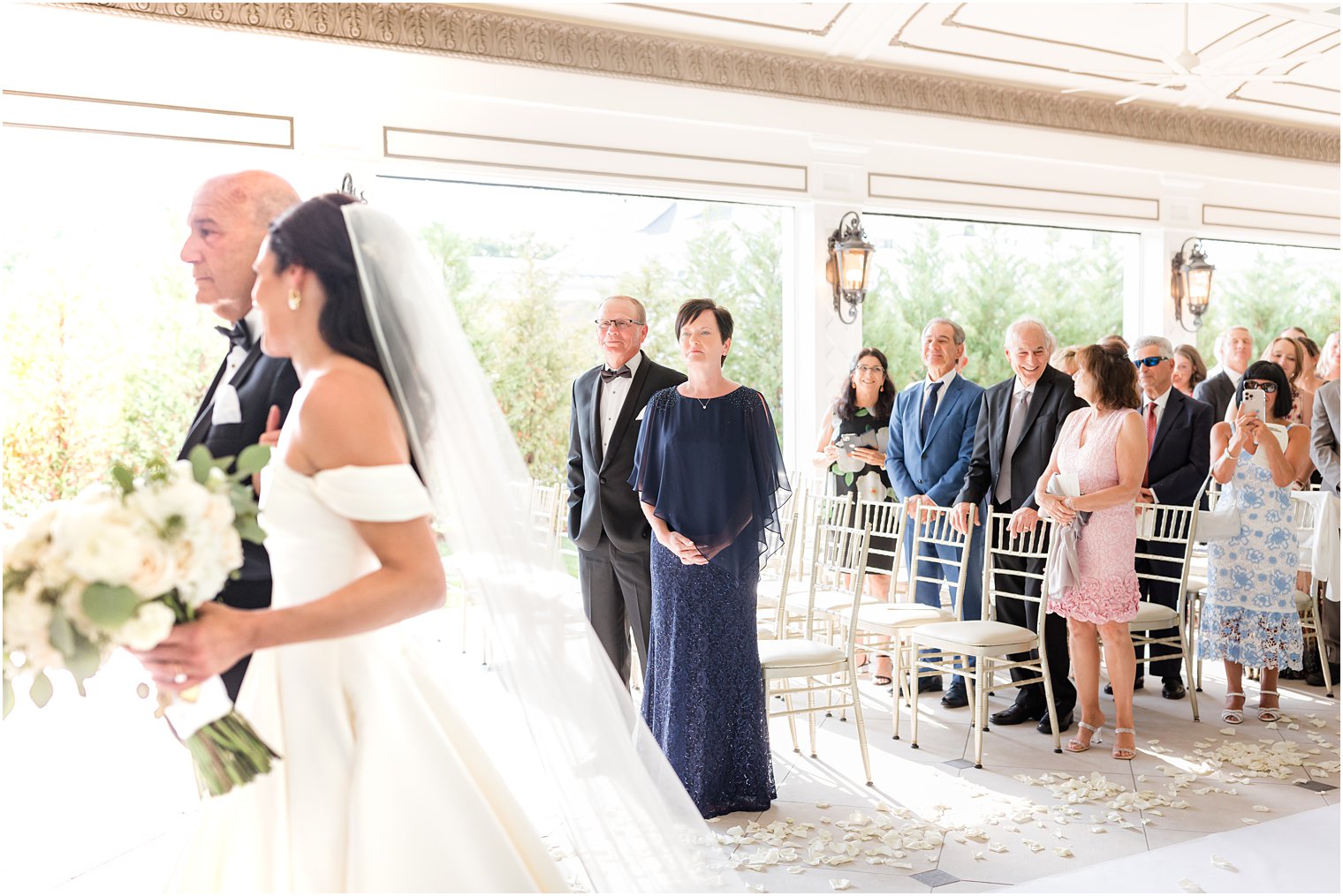 groom's mother stands watching ceremony