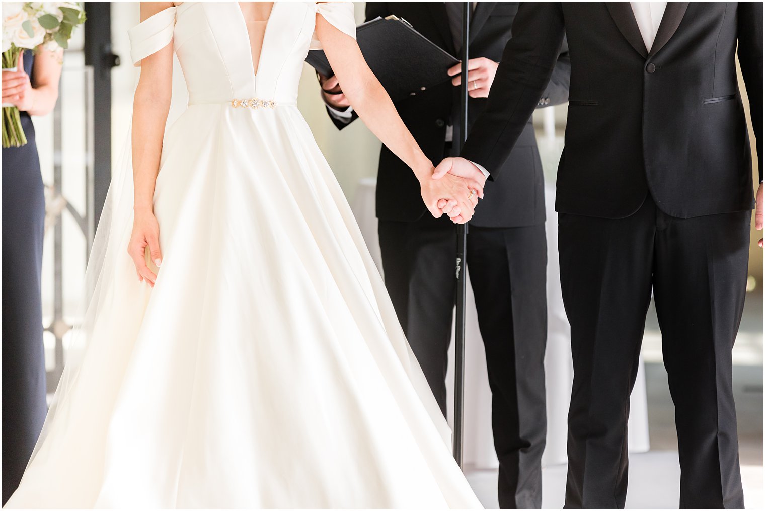 newlyweds hold hands after wedding ceremony at Shadowbrook at Shrewbsury